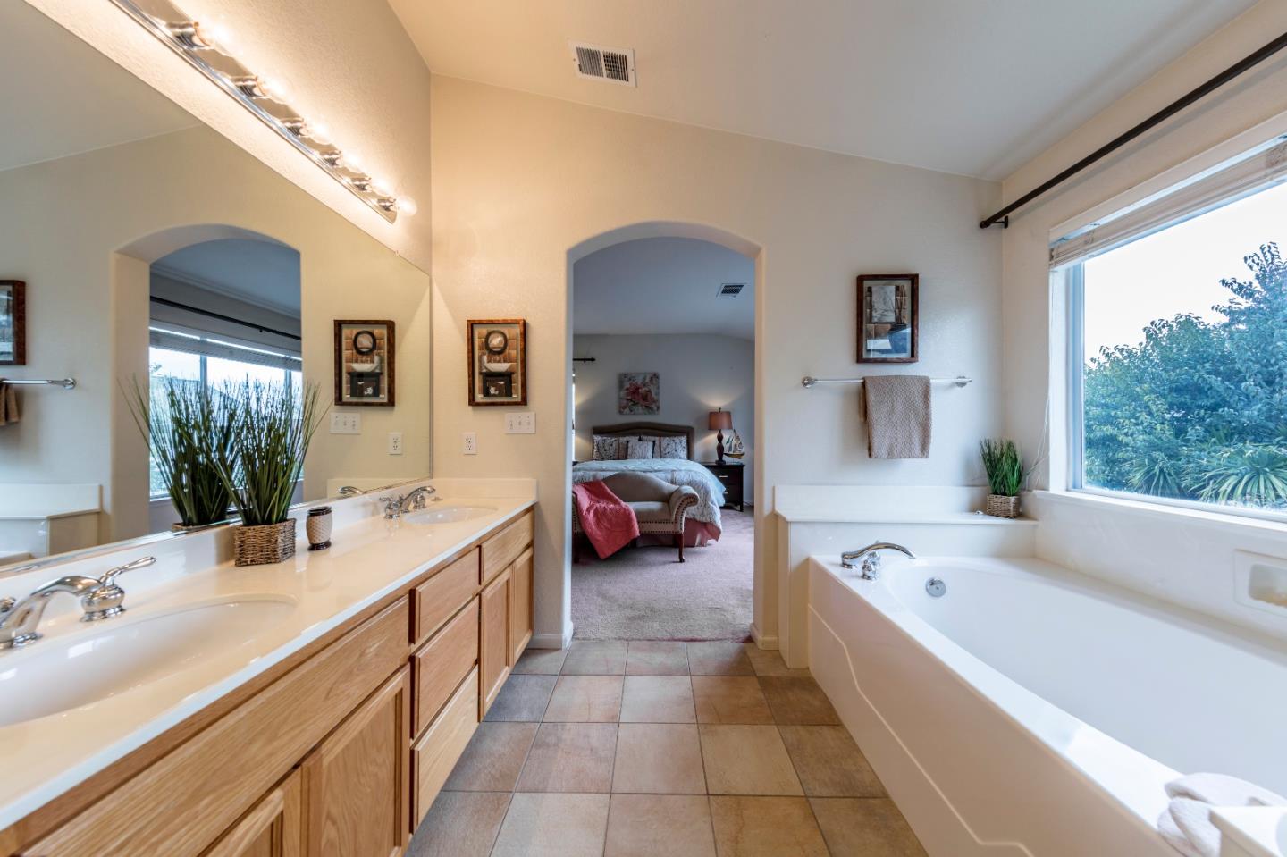 2235 Woodranch Road San Jose, CA 95131 - Photo 23 of 40 a spacious en suite bathroom with a granite countertop tub and a large window