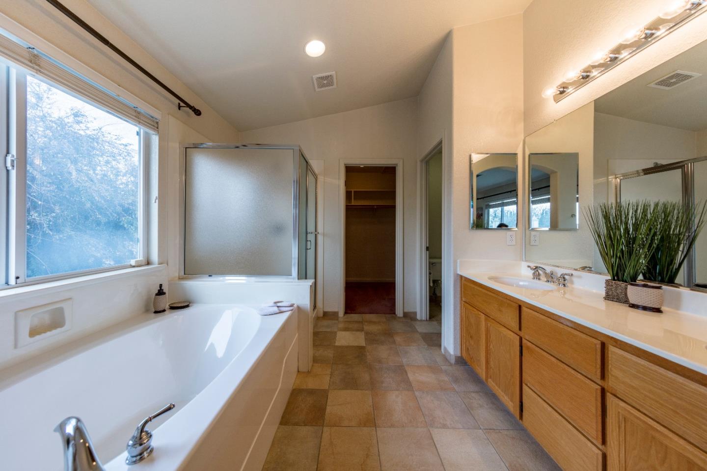 2235 Woodranch Road San Jose, CA 95131 - Photo 24 of 40 a bathroom with a double vanity sink large mirror and a bathtub