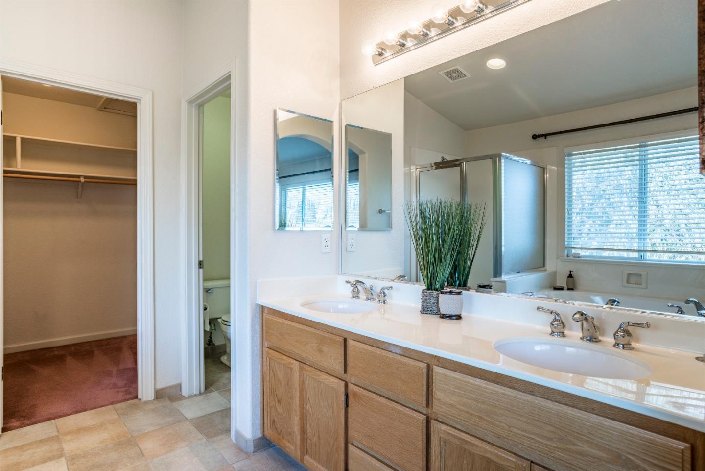 2235 Woodranch Road San Jose, CA 95131 - Photo 26 of 40 a bathroom with double vanity sinks and a mirror