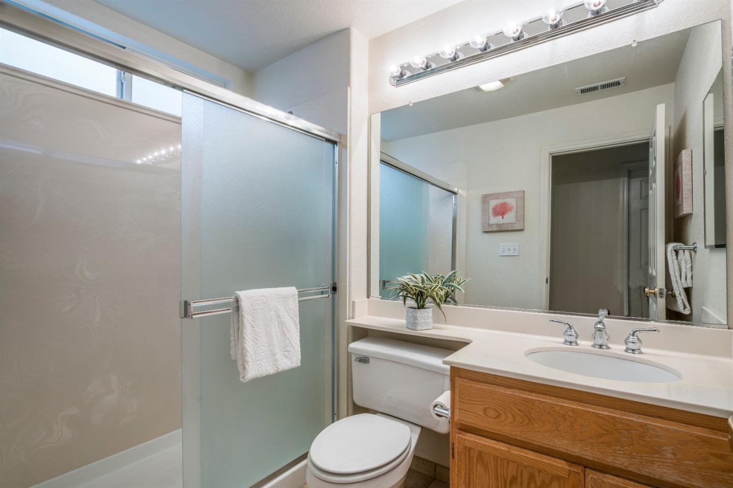 2235 Woodranch Road San Jose, CA 95131 - Photo 30 of 40 a bathroom with a granite countertop sink mirror vanity and toilet