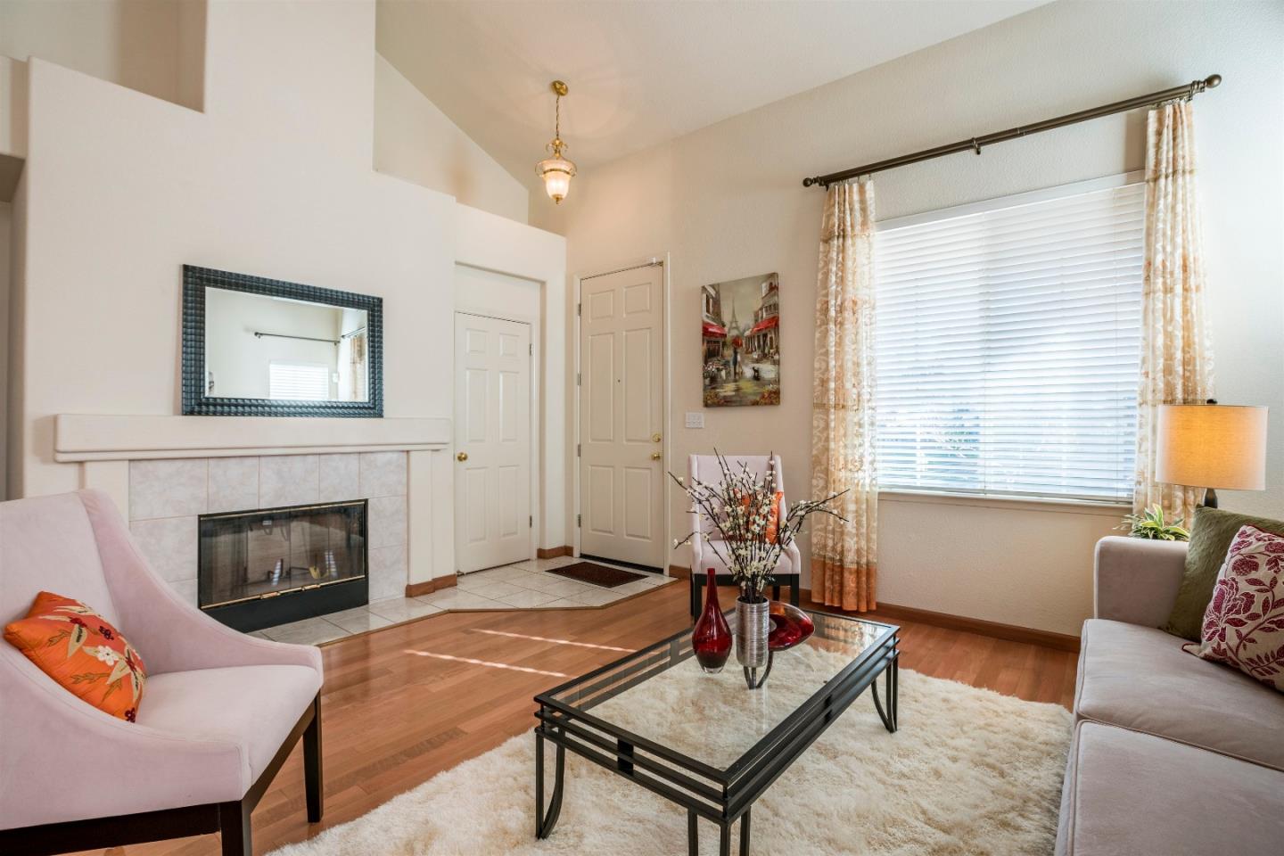 2235 Woodranch Road San Jose, CA 95131 - Photo 9 of 40 a living room with furniture a flat screen tv and a fireplace