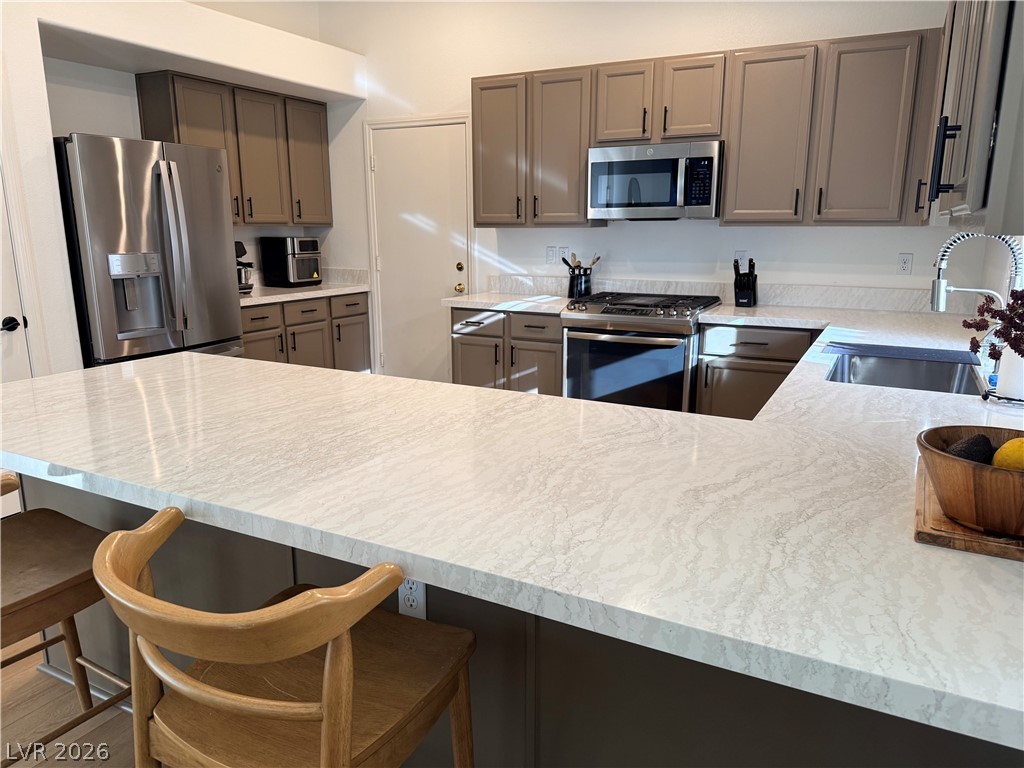 2122 Hidden Ranch Terrace Henderson, NV 89052 - Photo 2 of 4 Culinary aspirations come alive in this kitchen featuring abundant counter space and modern appliances.