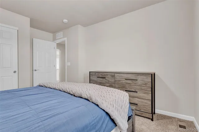 a bedroom with a bed and a dresser