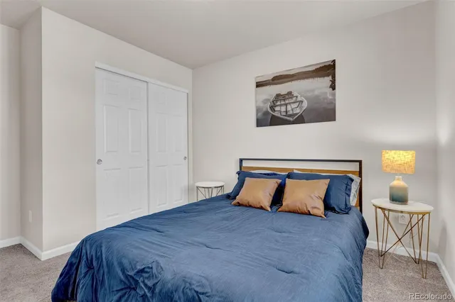 a bedroom with a bed and lamp