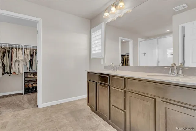 a bathroom with a shower and a glass door
