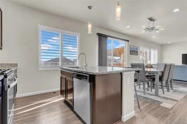 a kitchen with stainless steel appliances granite countertop a stove and a refrigerator