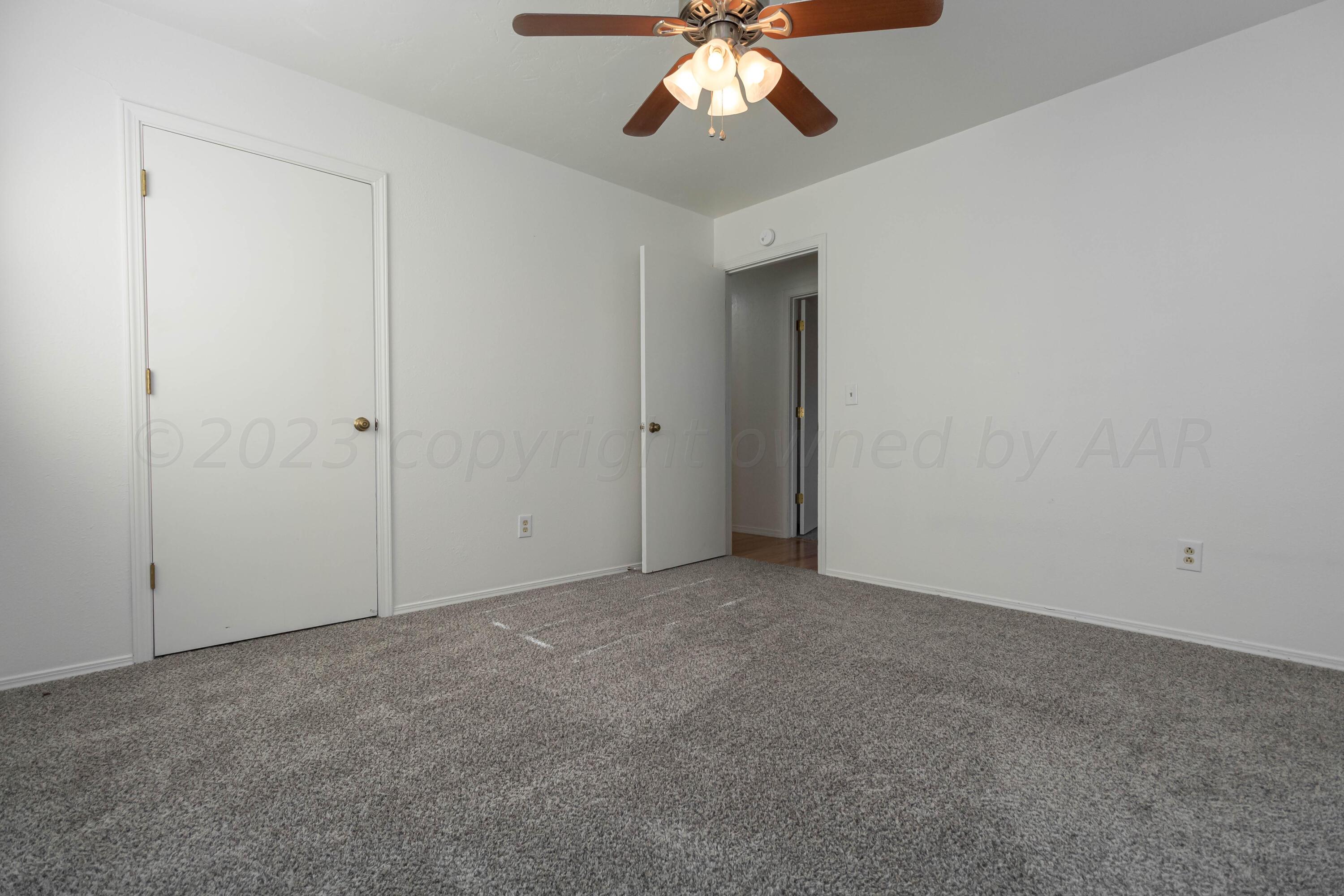 8204 Santa Fe Trail Amarillo, TX 79110 - Photo 11 of 13 an empty room with a chandelier fan
