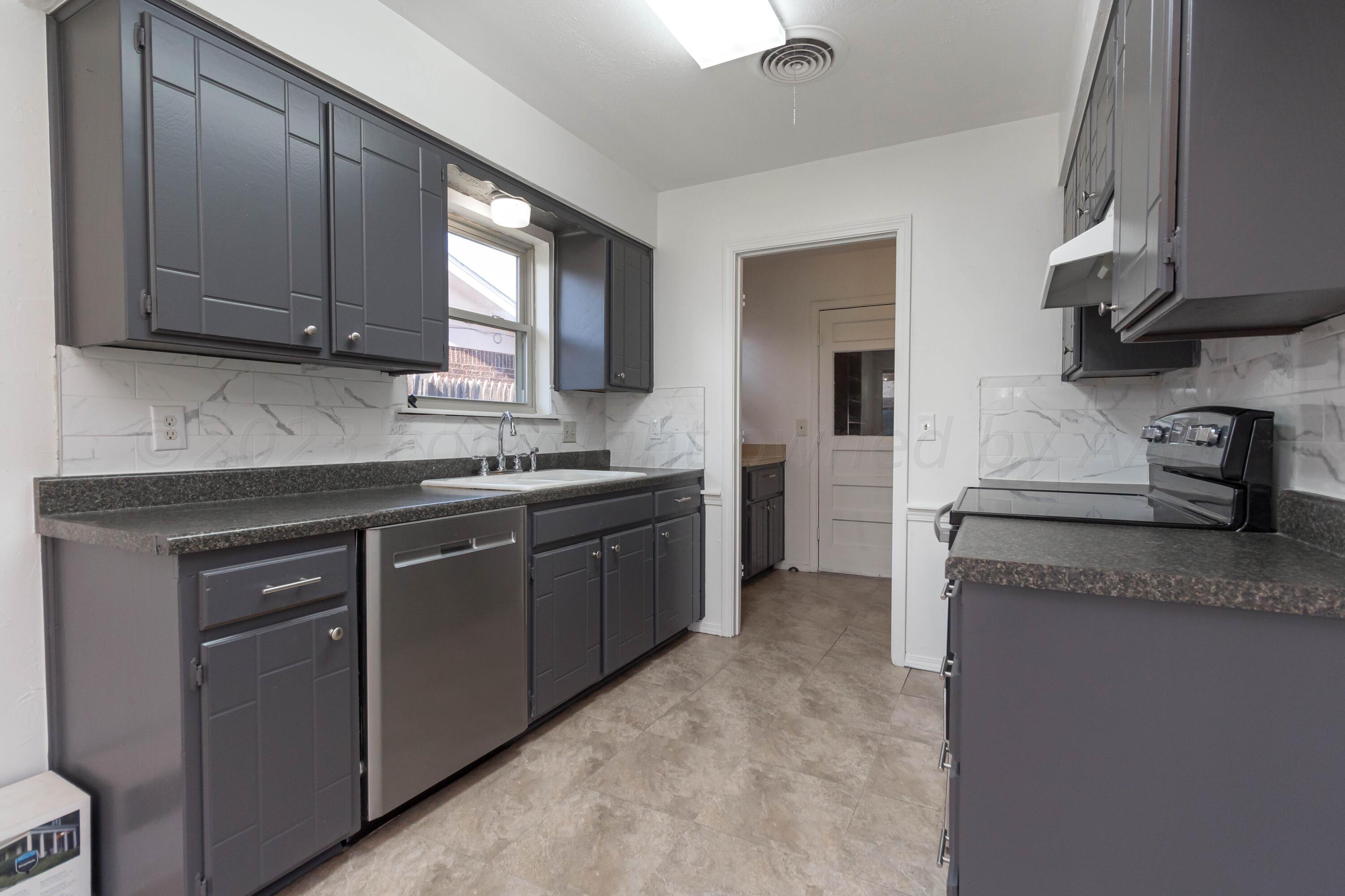 8204 Santa Fe Trail Amarillo, TX 79110 - Photo 3 of 13 a kitchen with stainless steel appliances granite countertop a sink stove and cabinets