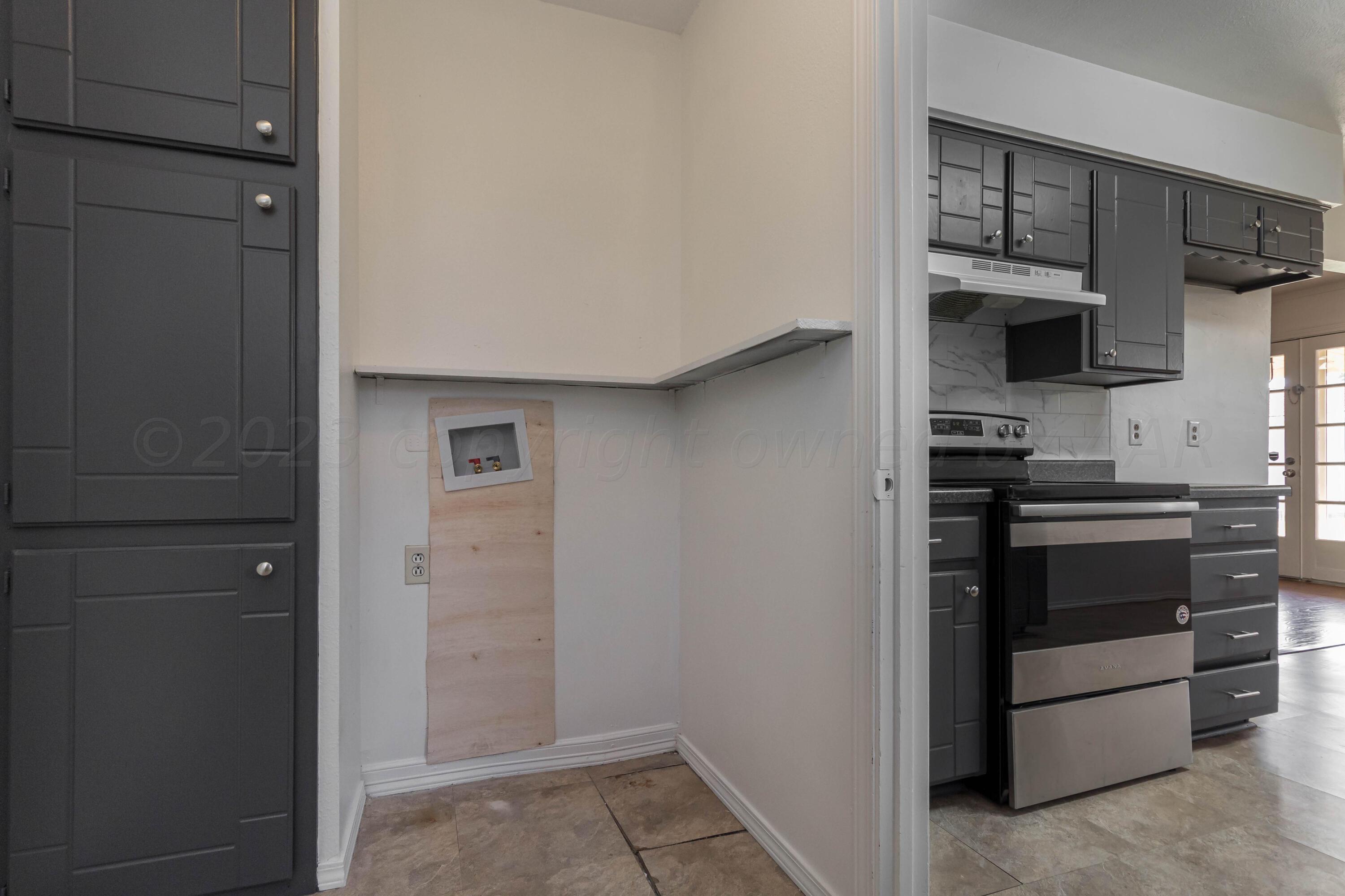8204 Santa Fe Trail Amarillo, TX 79110 - Photo 5 of 13 a kitchen with a refrigerator and cabinets