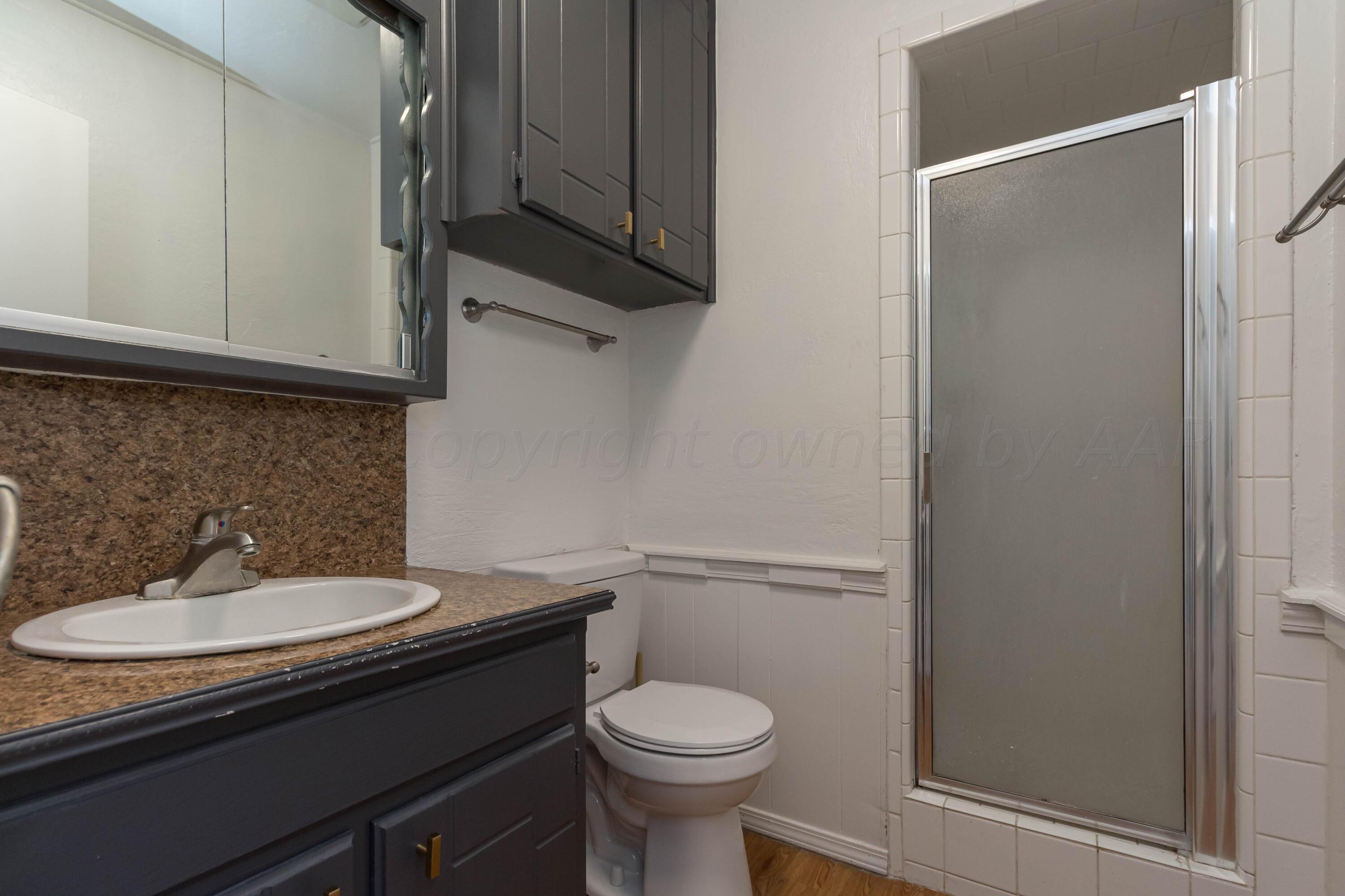 8204 Santa Fe Trail Amarillo, TX 79110 - Photo 8 of 13 a bathroom with a sink toilet and a mirror