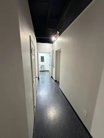 a view of hallway with stairs and wooden floor