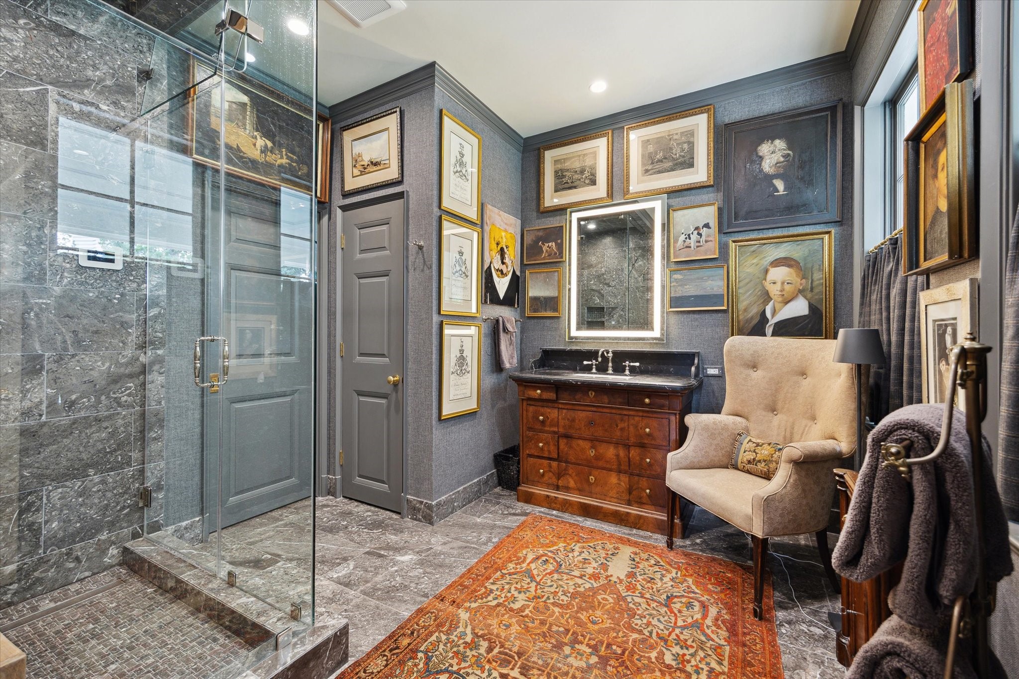 4019 Inverness Drive Houston, TX 77019 - Photo 25 of 49 Featuring an antique vanity topped with a natural stone counter, this primary bathroom offers a walk-in steam shower framed by natural stone surround. The private water closet includes a sleek TOTO Aquia bidet toilet, plus a separate urinal. Crown molding, heated natural stone floors, and recessed lighting complete the refined ambiance.