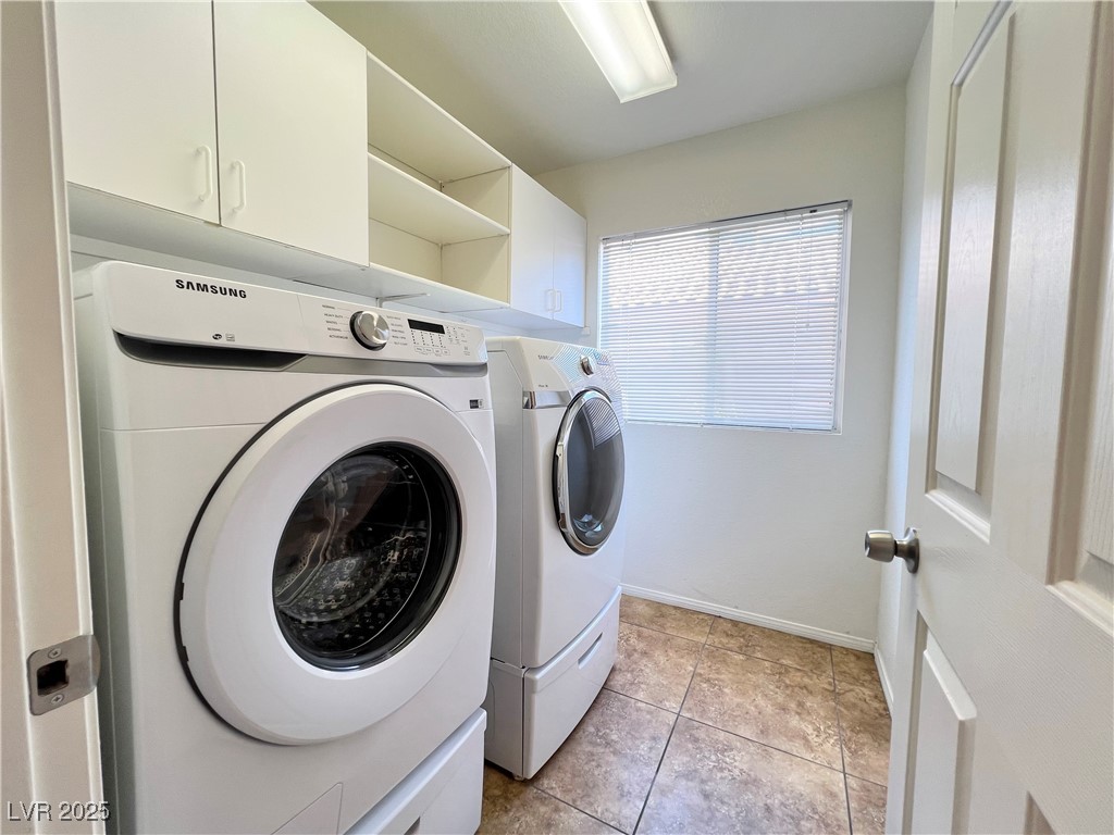 330 Forest Ridge Street Henderson, NV 89014 - Photo 16 of 45 Laundry room with washer and dryer and cabinets