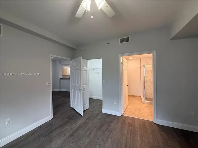 a view of empty room with wooden floor
