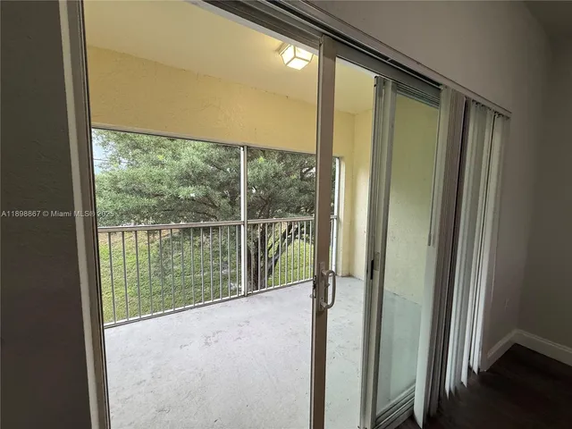 a view of a glass door and the balcony