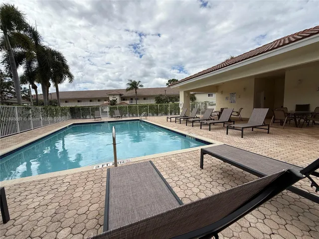 a view of swimming pool with chairs