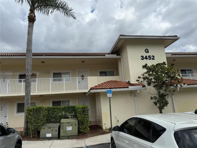 a front view of a house with plants