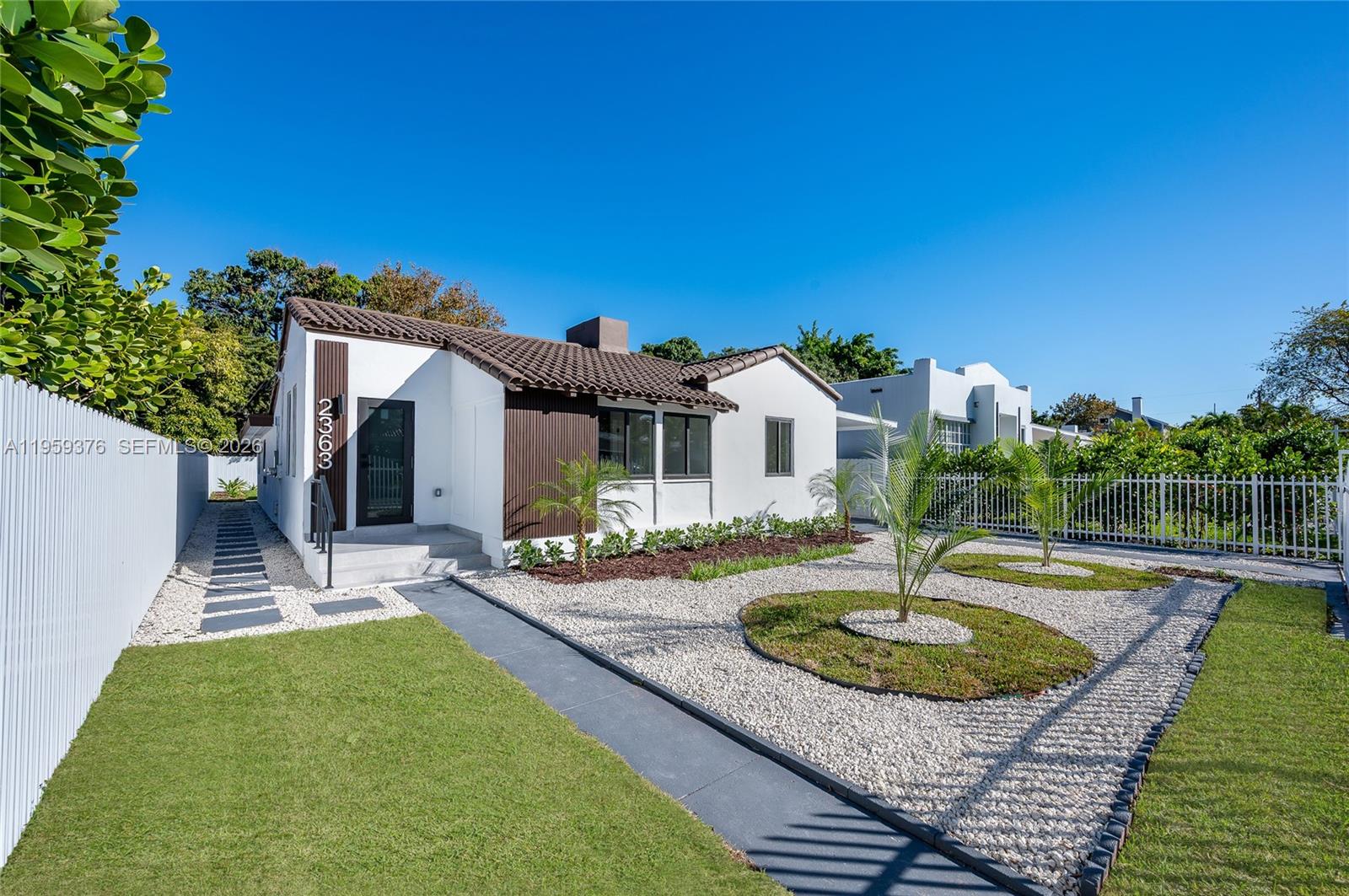 a front view of a house with garden