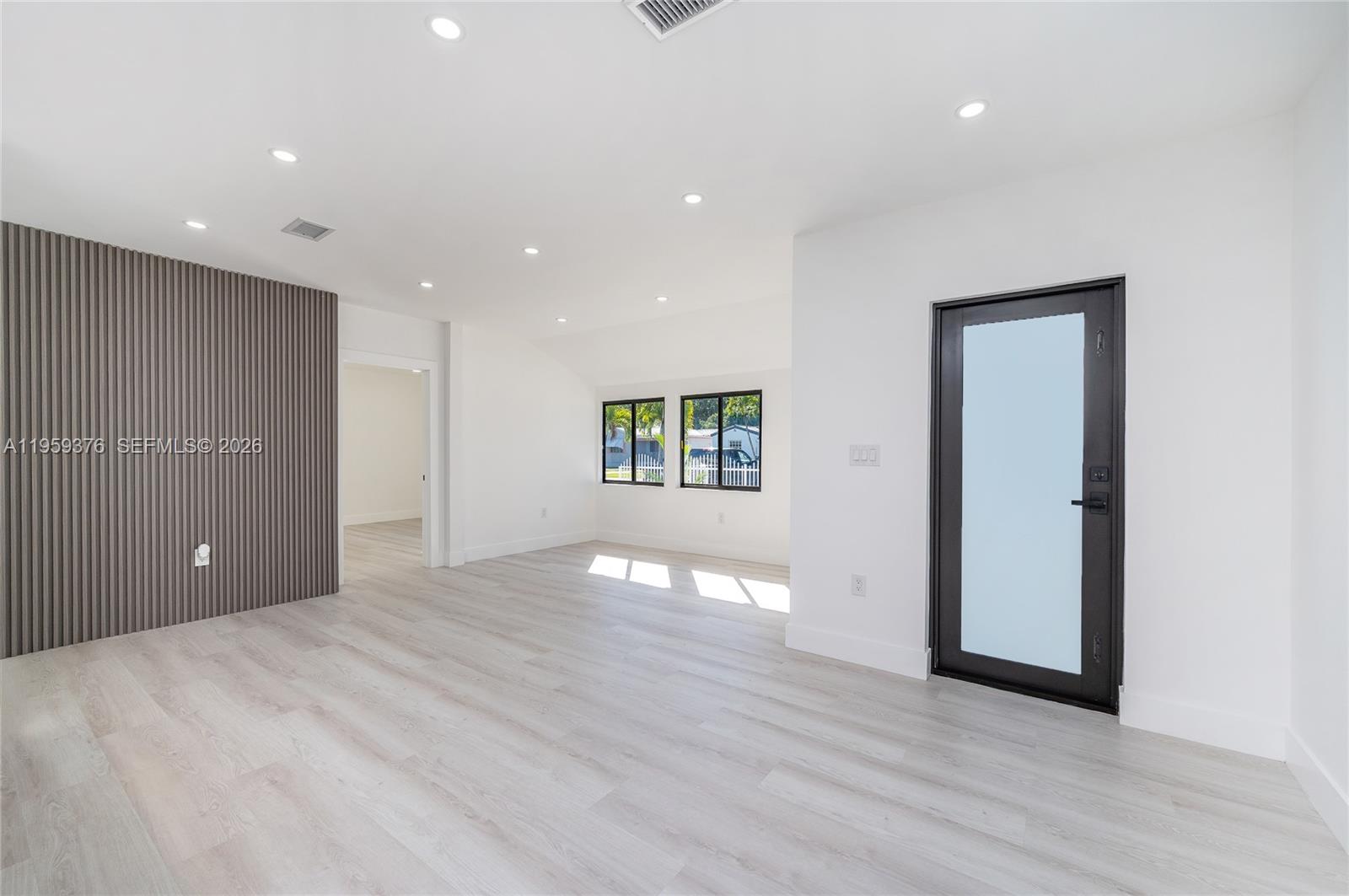 2363 Southwest 11th Terrace Miami, FL 33135 - Photo 11 of 49 a view of an empty room with wooden floor and a window