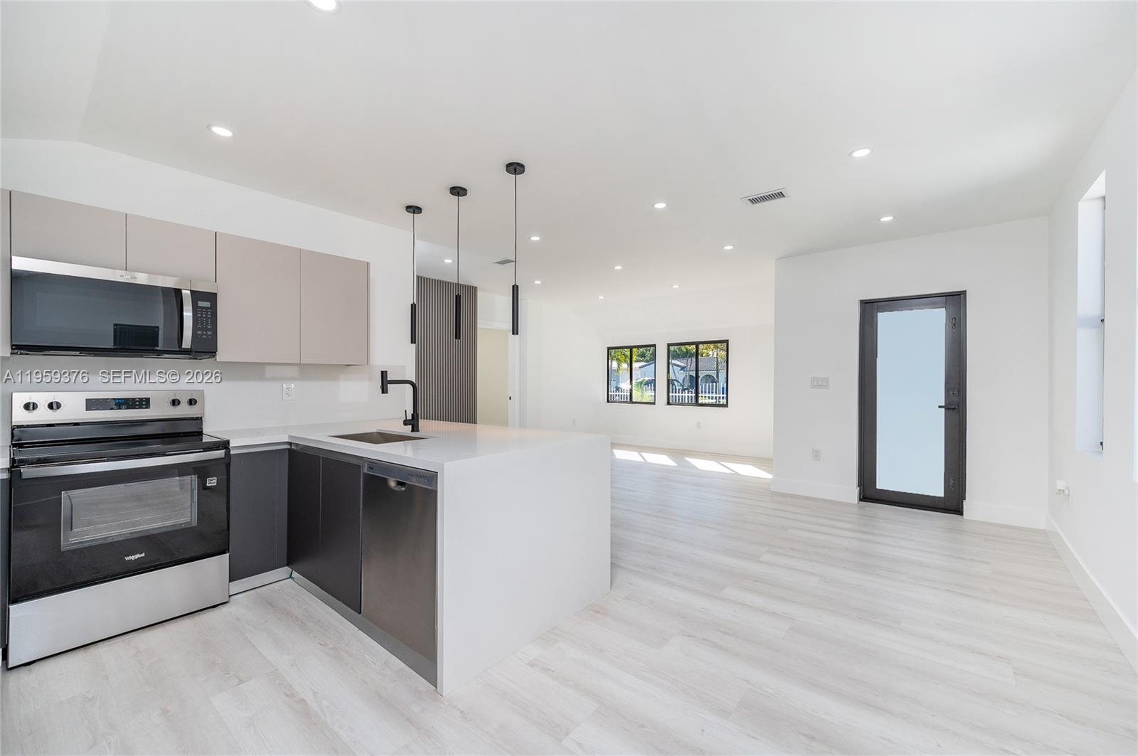 2363 Southwest 11th Terrace Miami, FL 33135 - Photo 12 of 49 a kitchen with stainless steel appliances granite countertop a stove and a sink