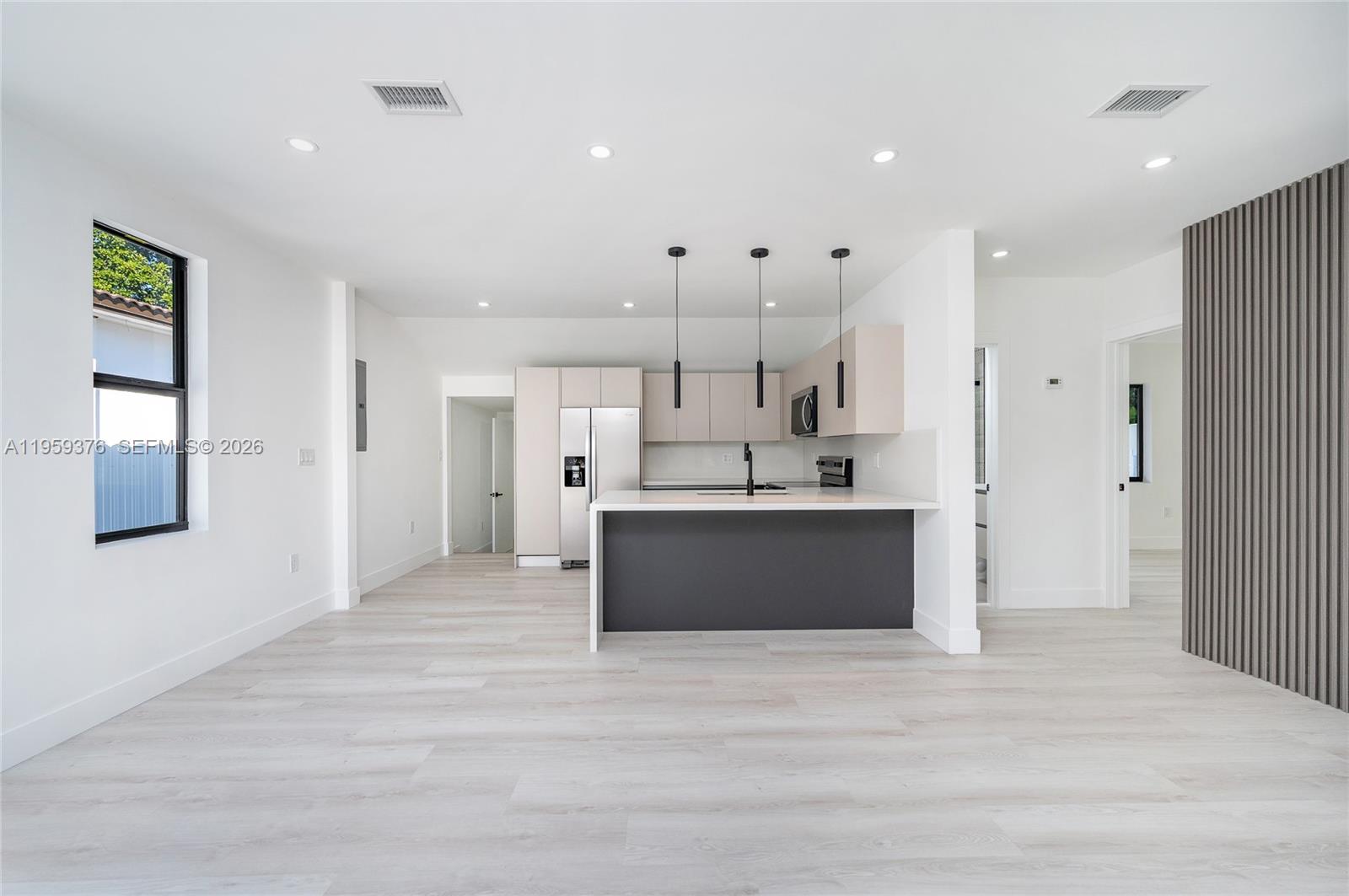 2363 Southwest 11th Terrace Miami, FL 33135 - Photo 14 of 49 a view of kitchen with kitchen island a sink stainless steel appliances and a fireplace