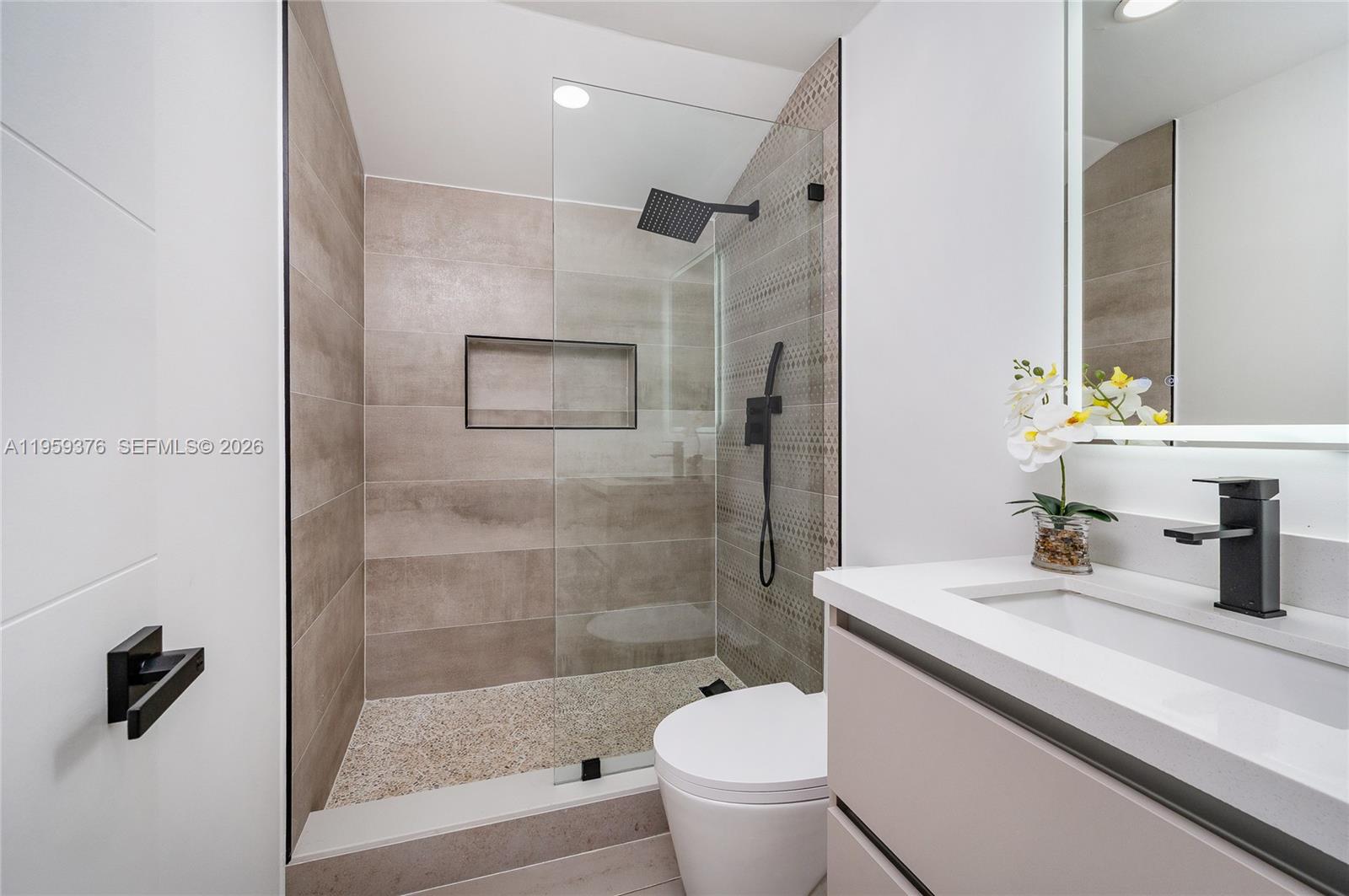 2363 Southwest 11th Terrace Miami, FL 33135 - Photo 17 of 49 a bathroom with a sink a toilet and shower