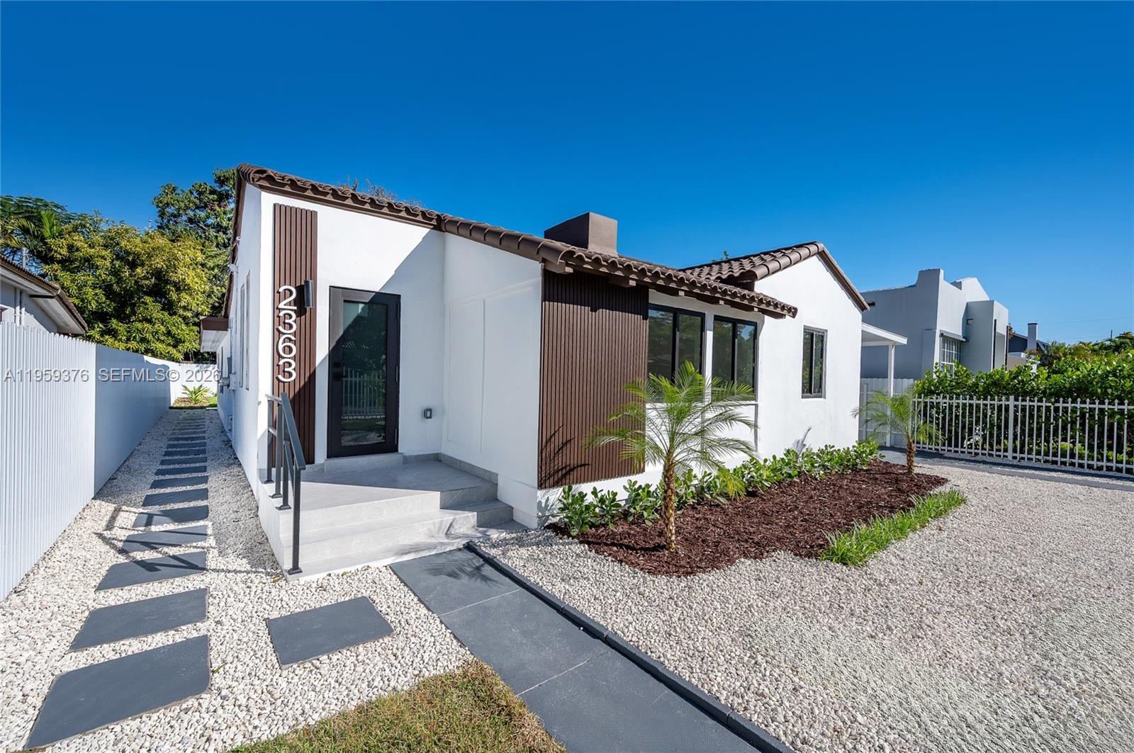 2363 Southwest 11th Terrace Miami, FL 33135 - Photo 2 of 49 a front view of a house with garden