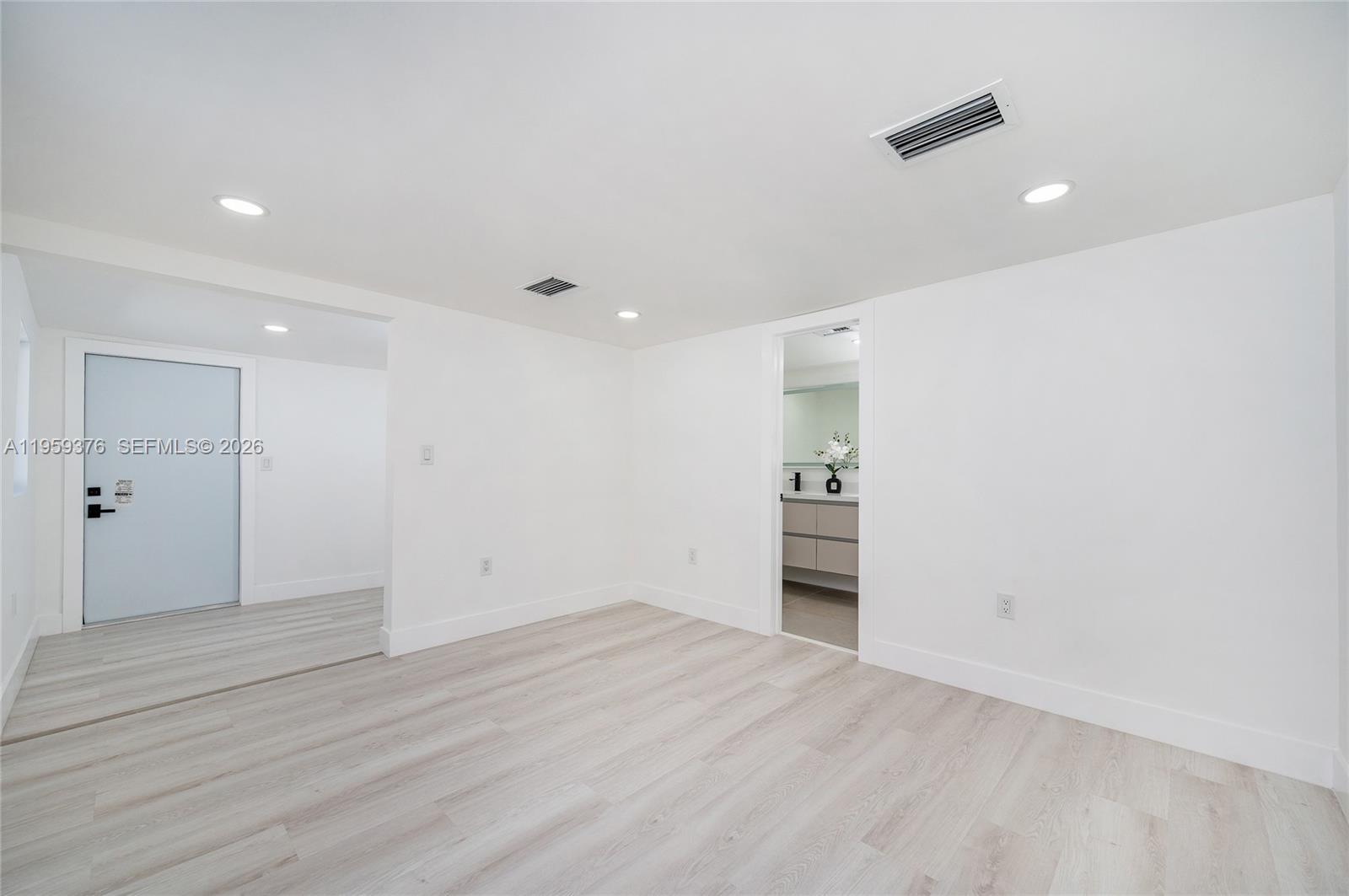 2363 Southwest 11th Terrace Miami, FL 33135 - Photo 25 of 49 an empty room with wooden floor and natural light