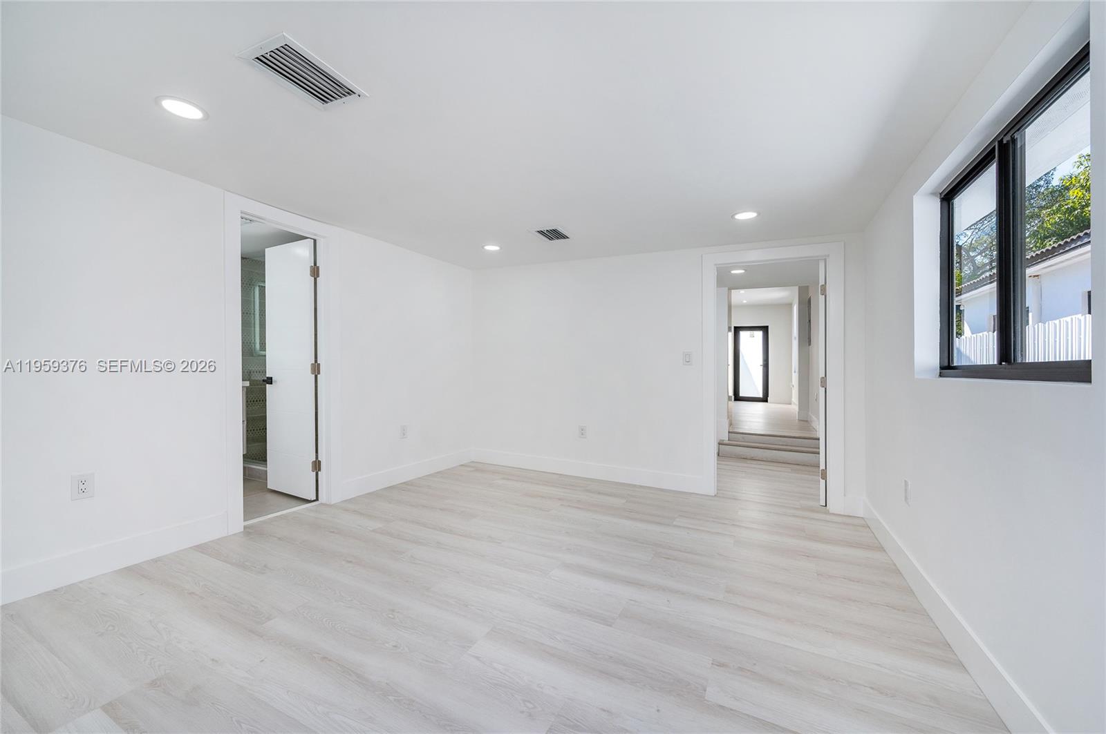 2363 Southwest 11th Terrace Miami, FL 33135 - Photo 29 of 49 wooden floor in an empty room with a window