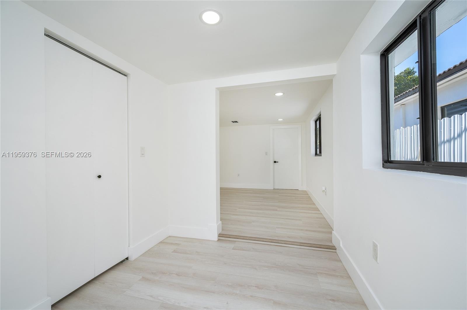 2363 Southwest 11th Terrace Miami, FL 33135 - Photo 31 of 49 a view of an empty room with wooden floor and a window