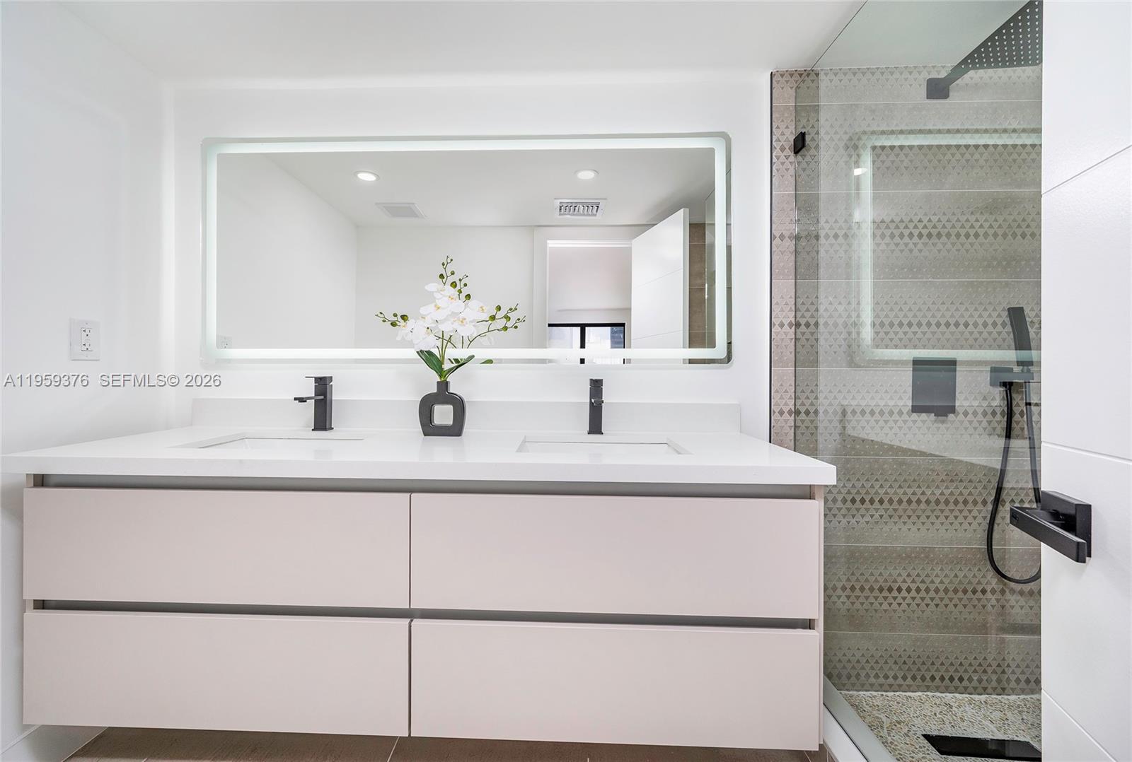 2363 Southwest 11th Terrace Miami, FL 33135 - Photo 33 of 49 a bathroom with a sink and mirror