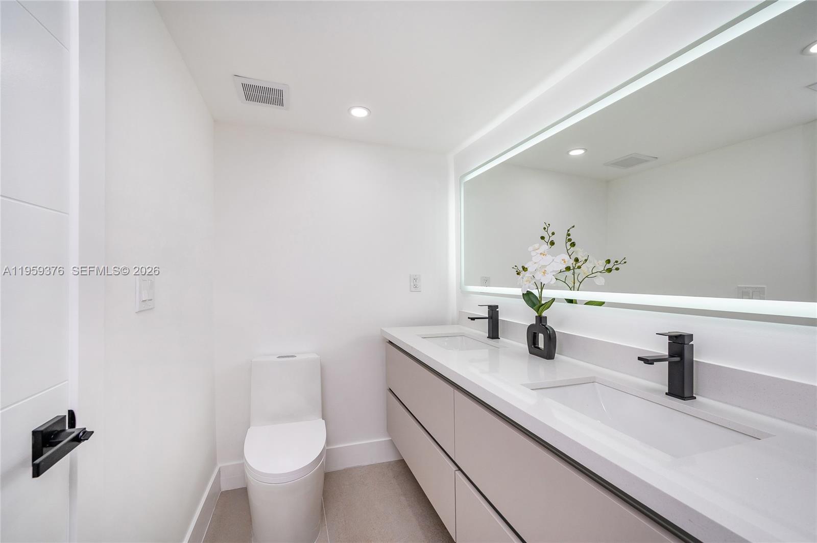 2363 Southwest 11th Terrace Miami, FL 33135 - Photo 34 of 49 a bathroom with a sink toilet and mirror