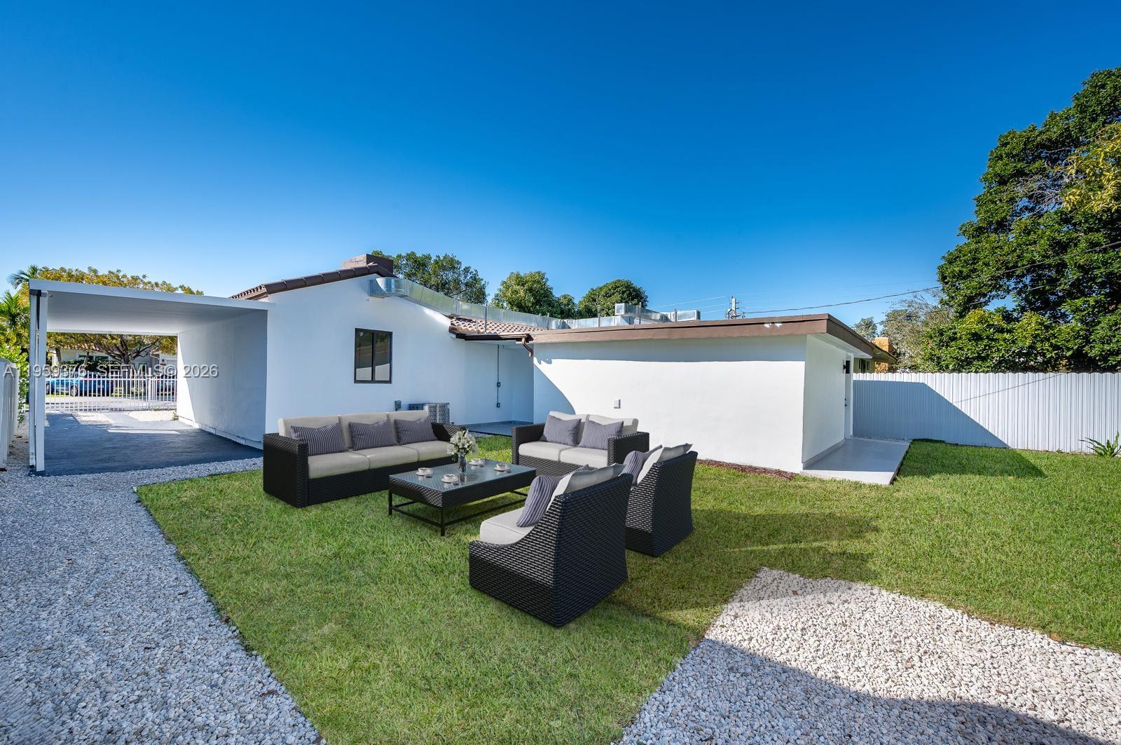 2363 Southwest 11th Terrace Miami, FL 33135 - Photo 38 of 49 a view of a backyard with couches plants and large trees