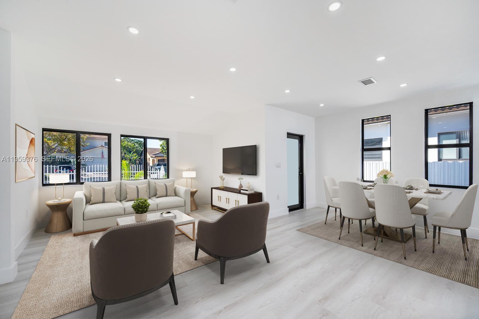 2363 Southwest 11th Terrace Miami, FL 33135 - Photo 6 of 49 a living room with furniture flat screen tv and a large window