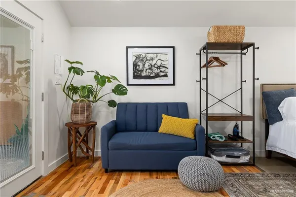 a living room with furniture and wooden floor