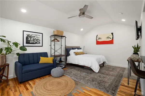 a bedroom with furniture and a rug