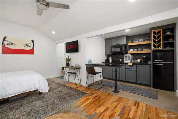 a bedroom with furniture and a flat screen tv