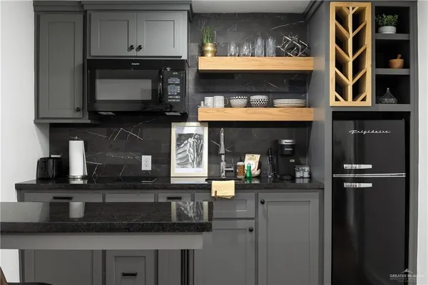 a kitchen with stainless steel appliances granite countertop a stove and a microwave