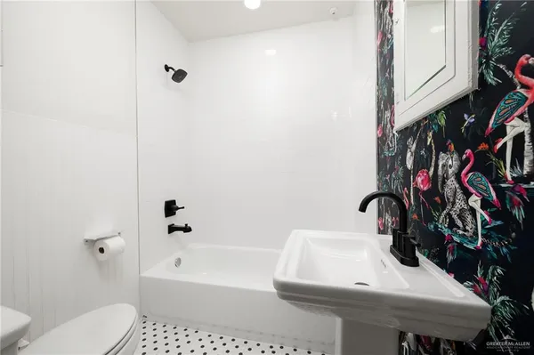 a bathroom with a sink toilet and shower