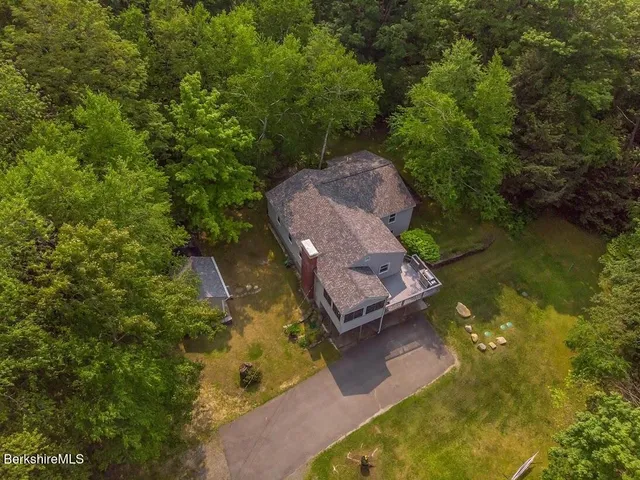 an aerial view of a house with a yard