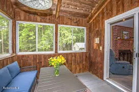 a living room with furniture and a floor to ceiling window