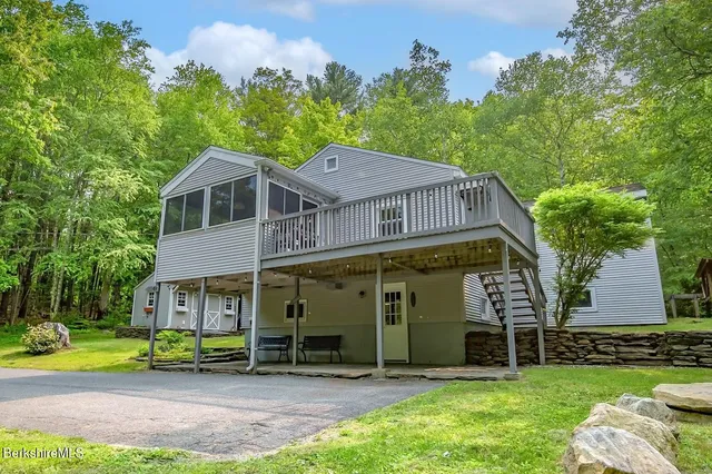 a view of a house with a yard and sitting area