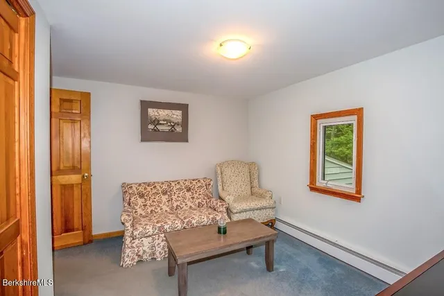 a living room with furniture a lamp and a window