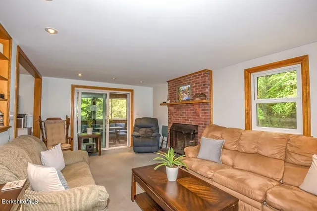 a living room with furniture fireplace and a large window