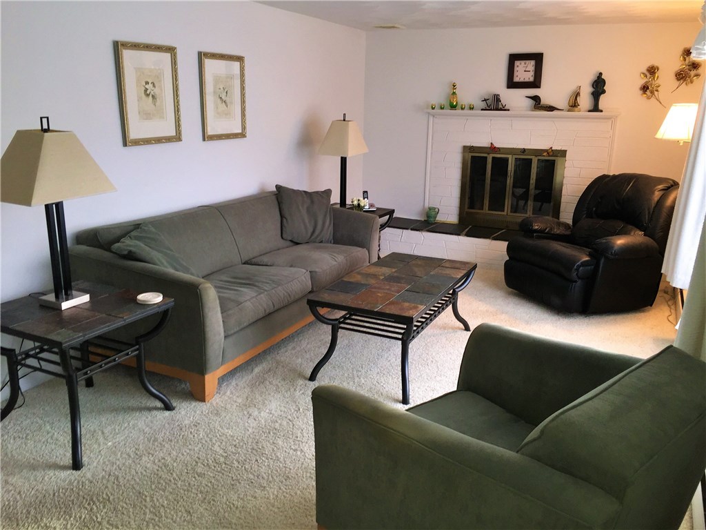 5 Ruth Street Middletown, RI 02842 - Photo 3 of 26 Living Room with fireplace . . . hardwood floors beneath carpet.