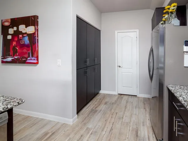 a view of a room with wooden floor and a fireplace
