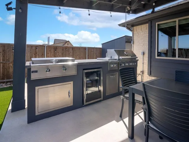 a view of a backyard with lawn chairs