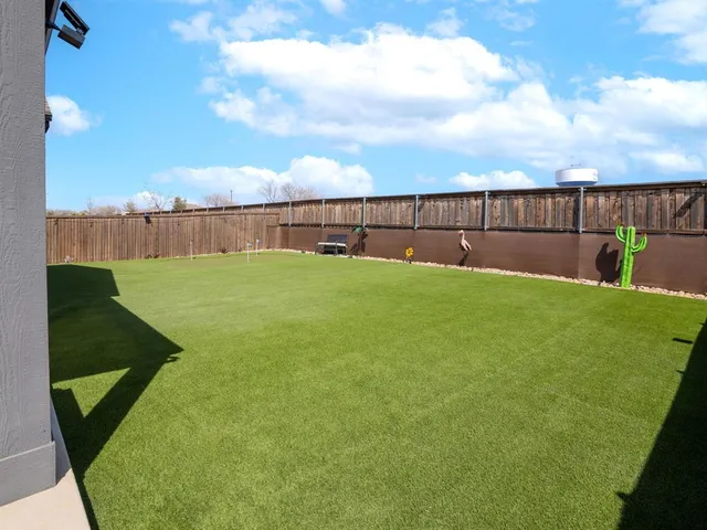 a view of a house with a yard and sitting area