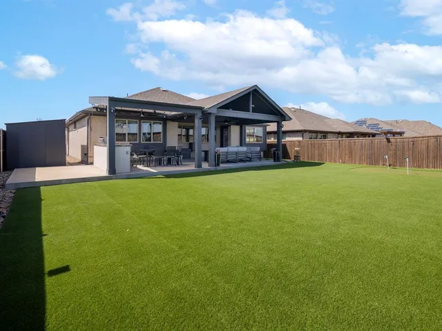 a front view of a house with a yard table and chairs