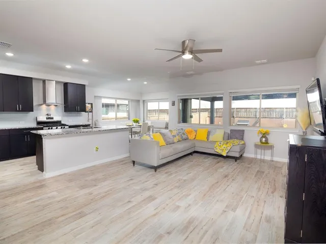 a living room with furniture and kitchen view